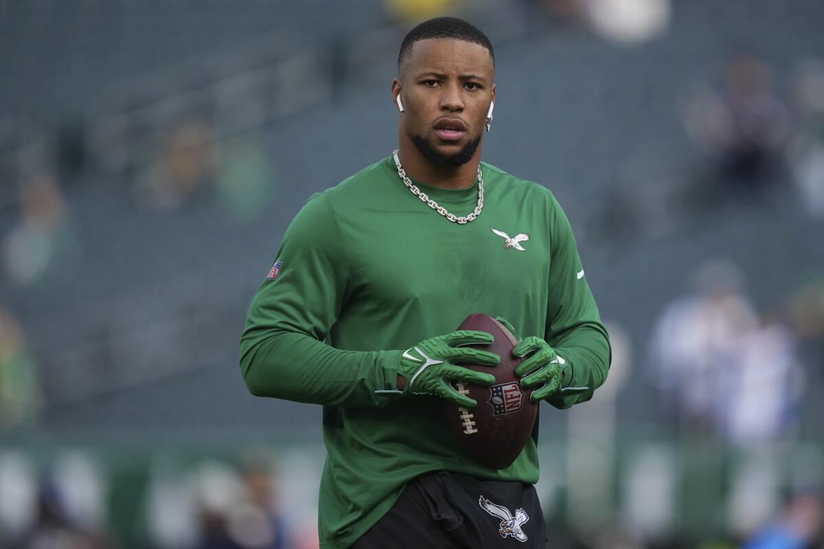 Philadelphia Eagles' Saquon Barkley warms up before an NFL football game, Sunday, Dec. 29, 2024, in Philadelphia. 