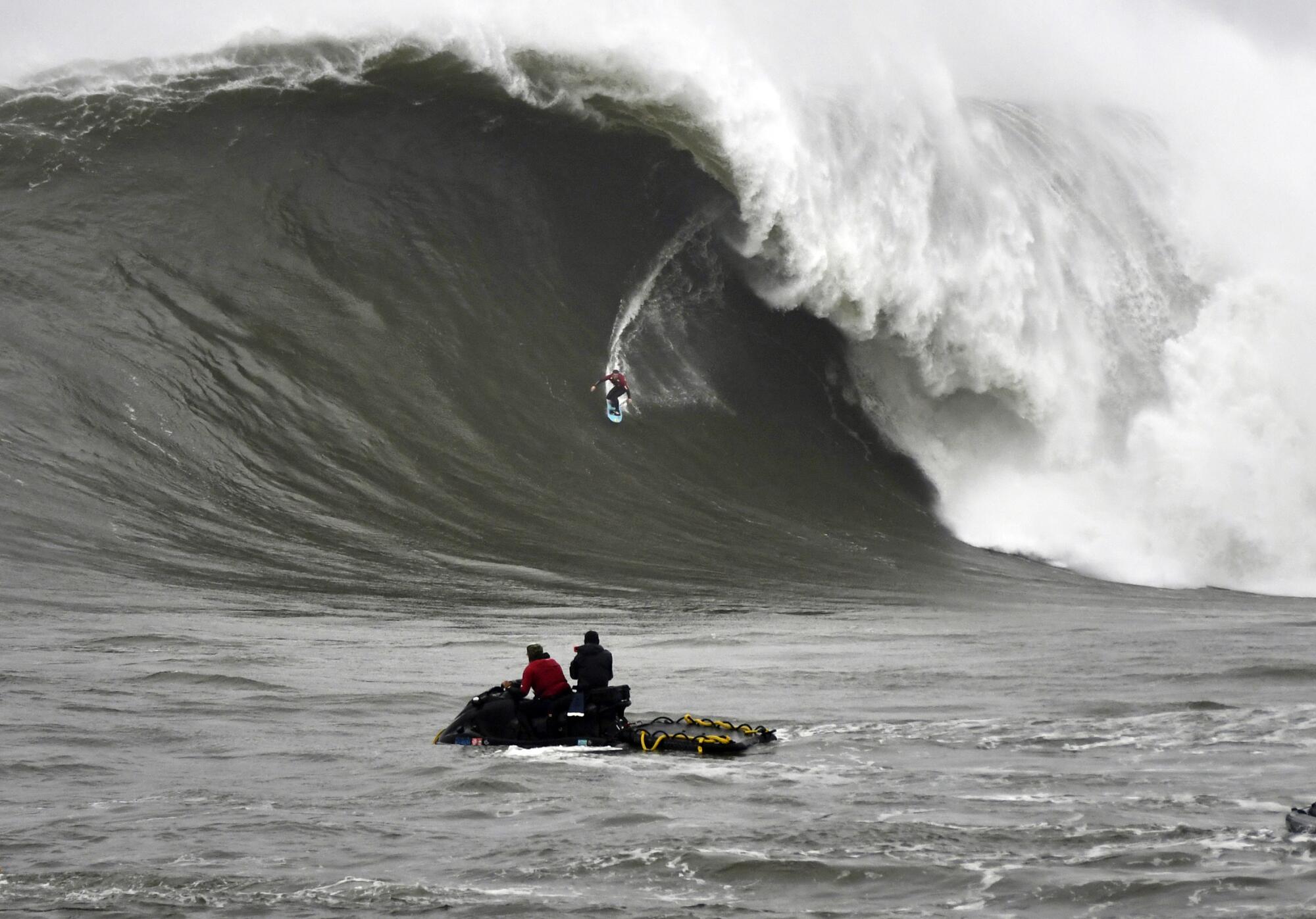 Surfer Alo Slebir barrels down a massive curling wave at Mavericks in Half Moon Bay.