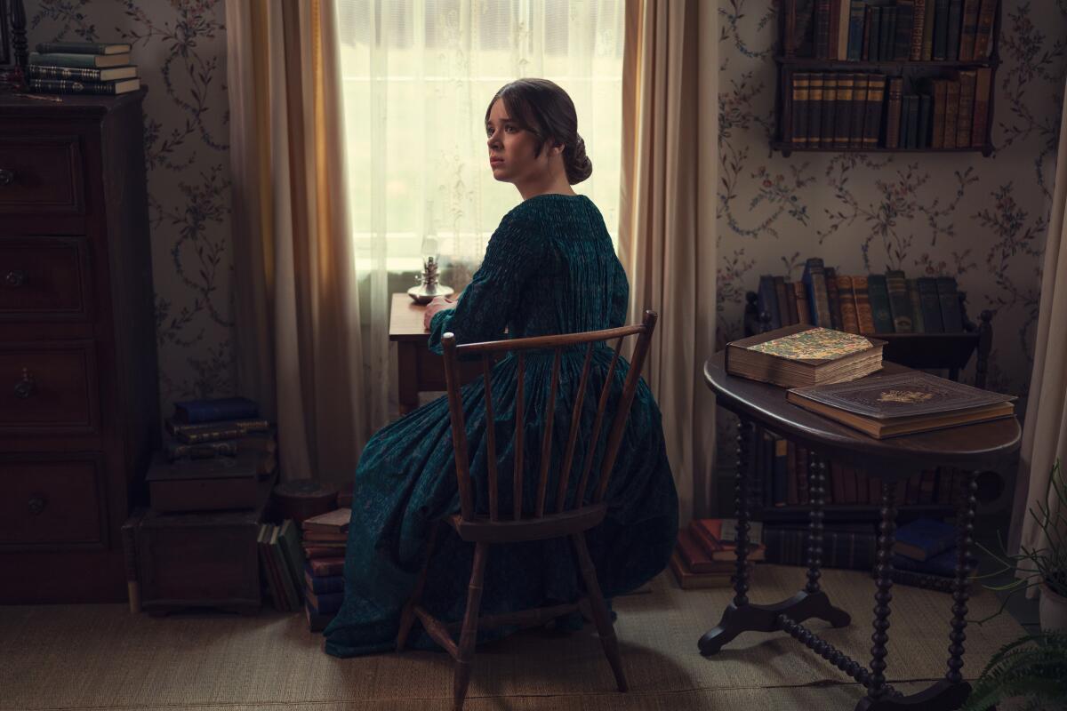 Hailee Steinfeld as the young 19th-century poet sitting at desk in a room in "Dickinson."