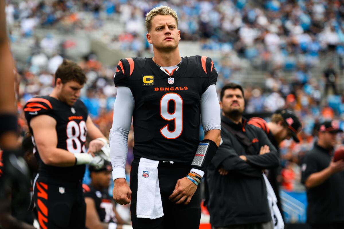 Joe Burrow in a football uniform on the field near other players