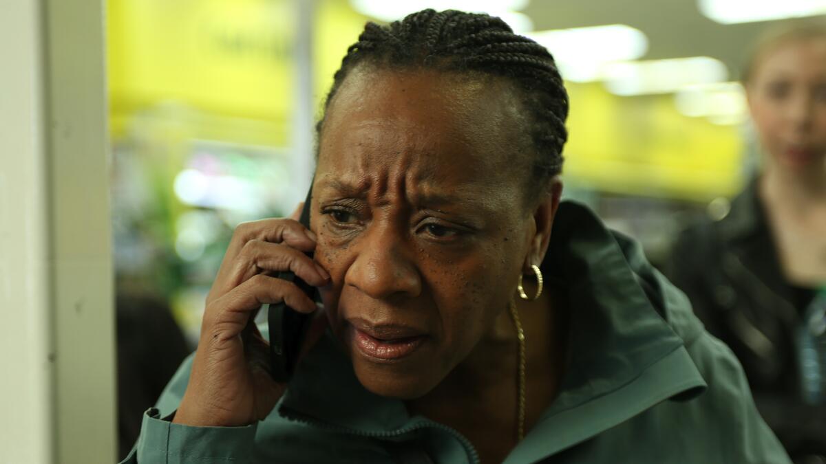 A woman speaks into a cellphone.