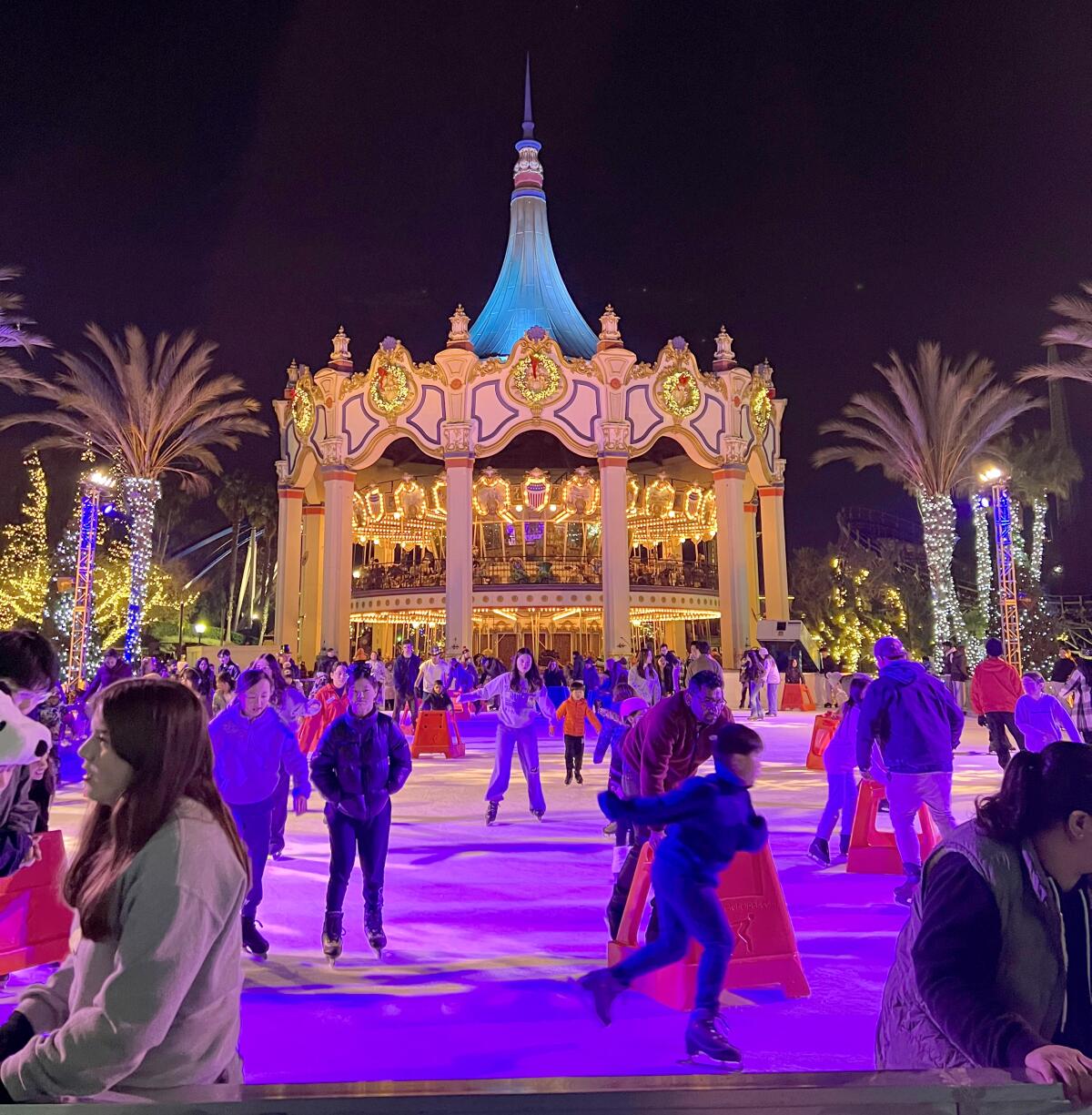 People ice skating in front of the carousel at California's Great America.