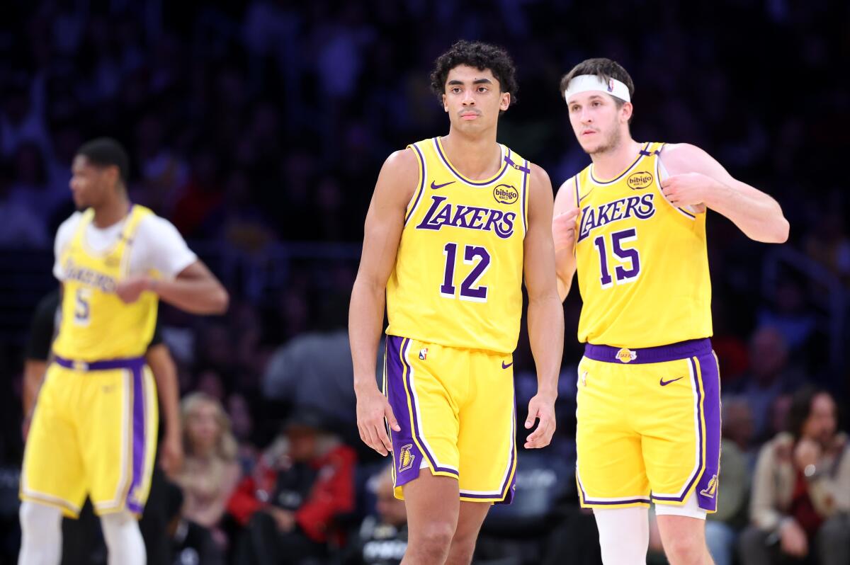 Lakers guard Austin Reaves, right talks with teammate Max Christie, left during a loss to the Cavaliers on Tuesday. 