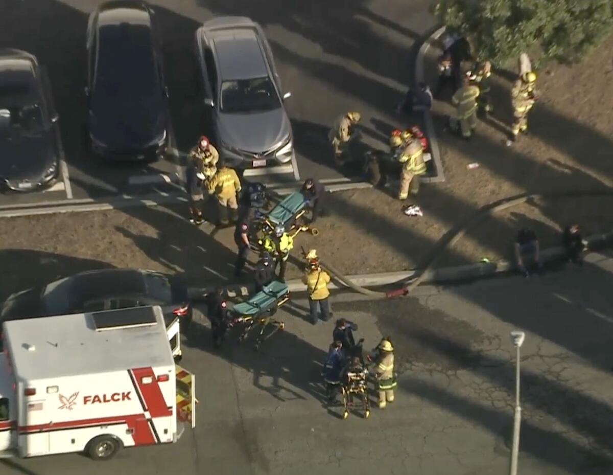 Fire Department personnel respond to plane crash near the Fullerton Airport on Thursday.