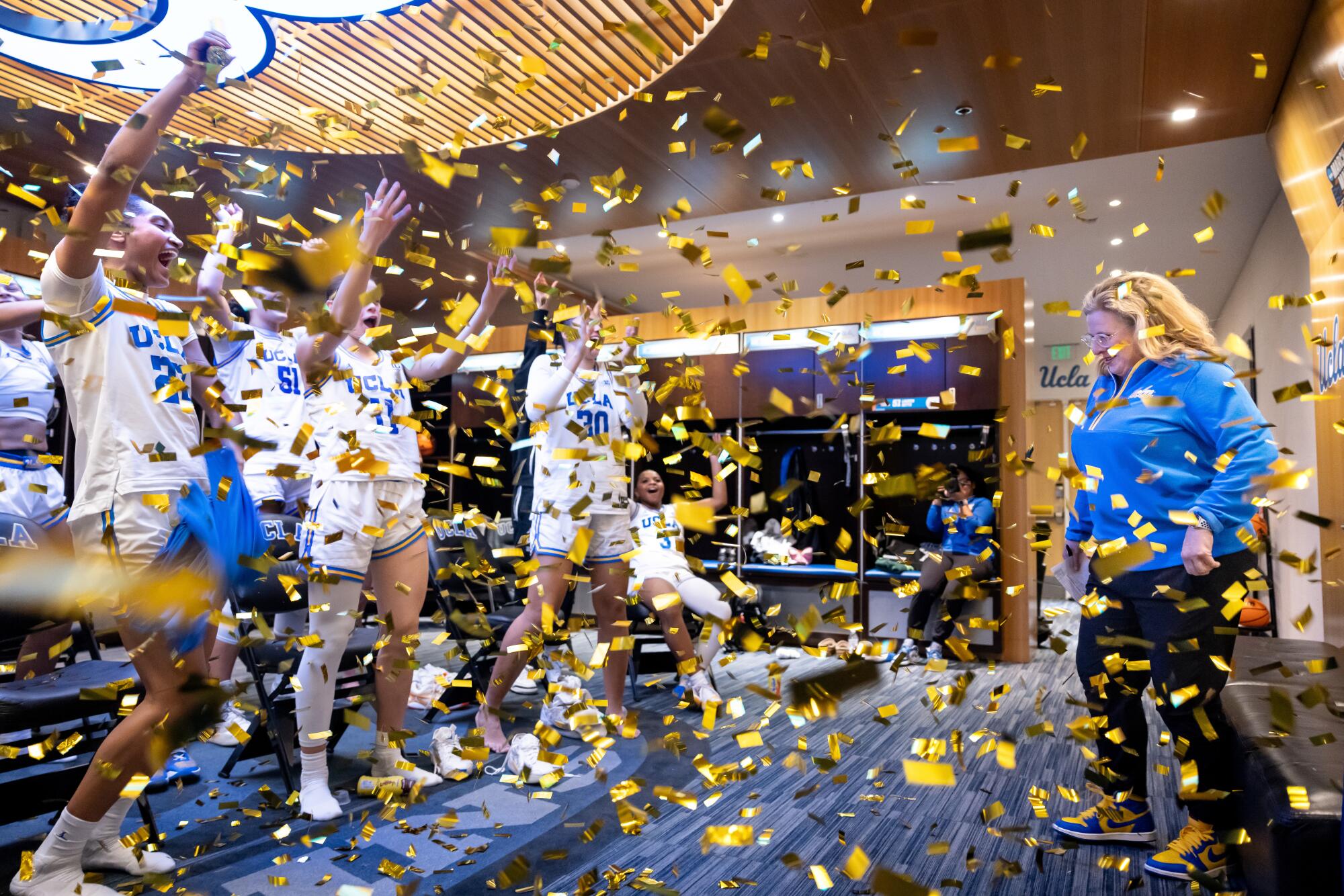 UCLA women's basketball players congratulate coach Cori Close after her 300th career win