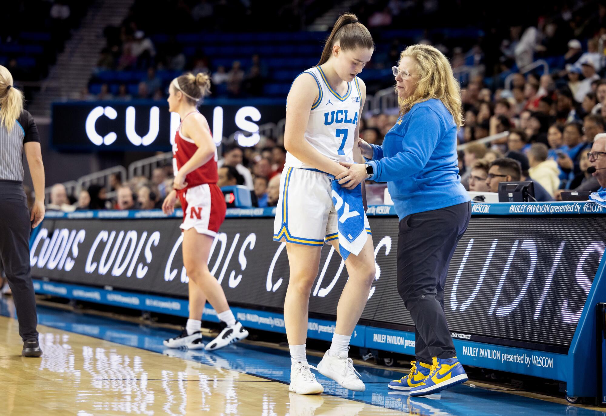 Cori Close, right, checks in with Elina Aarnisalo during a game against Nebraska at Pauley Pavilion.