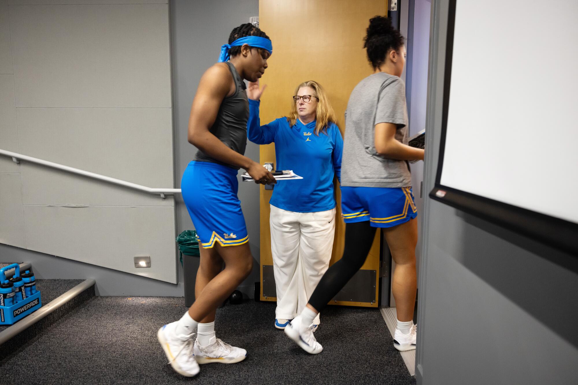 UCLA Women's Basketball Head Coach Cori Close, center, sees her team off to practice.