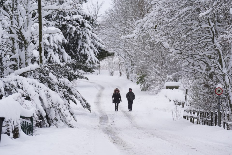 People walk in the snow near Allenheads in the Pennines in Northumberland