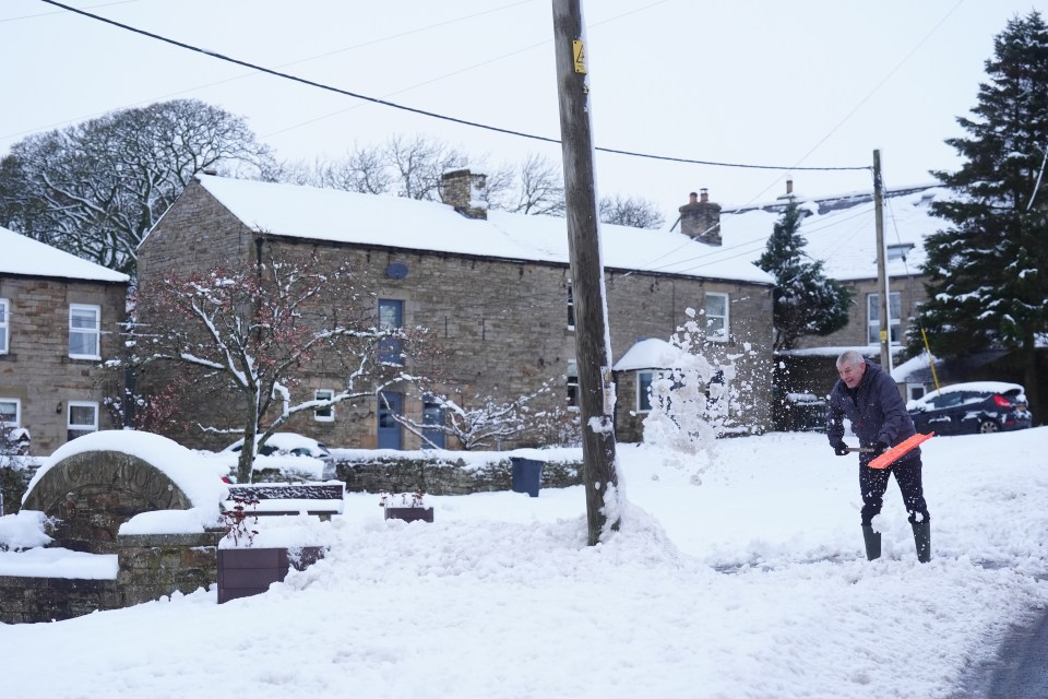 A man clears snow in Catton, Northumberland