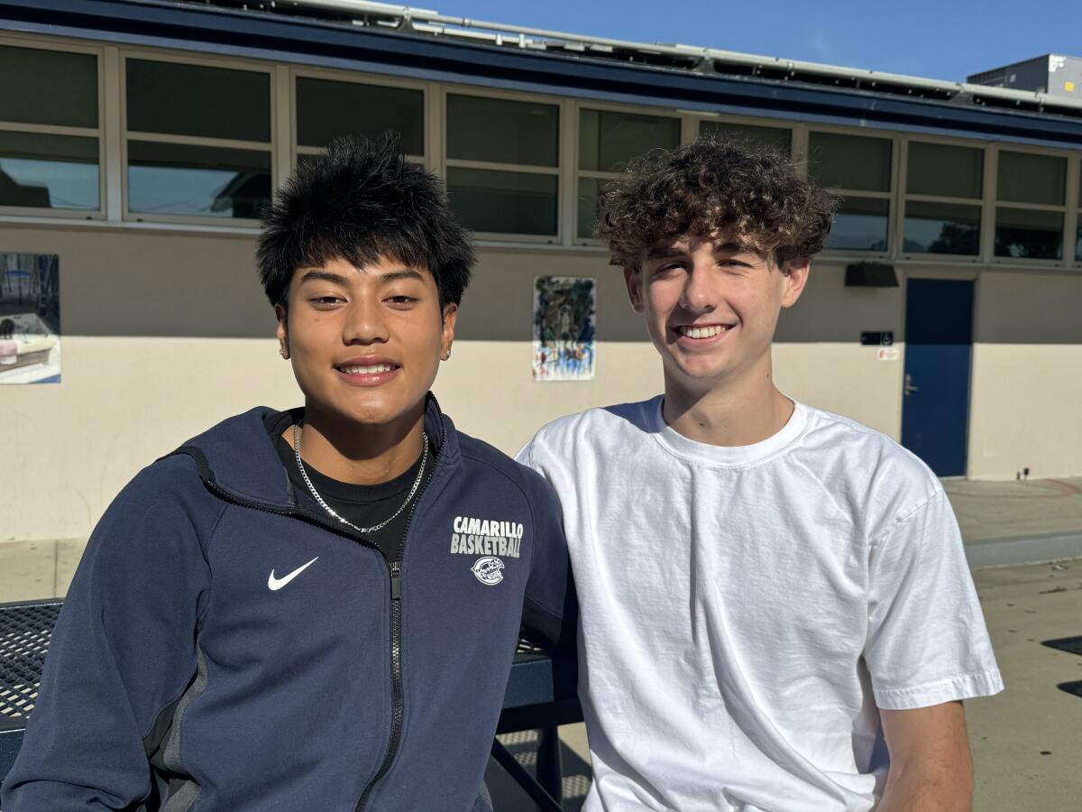 Evan Dela Paz (left) and Jackson Yeates pose for a photo together.