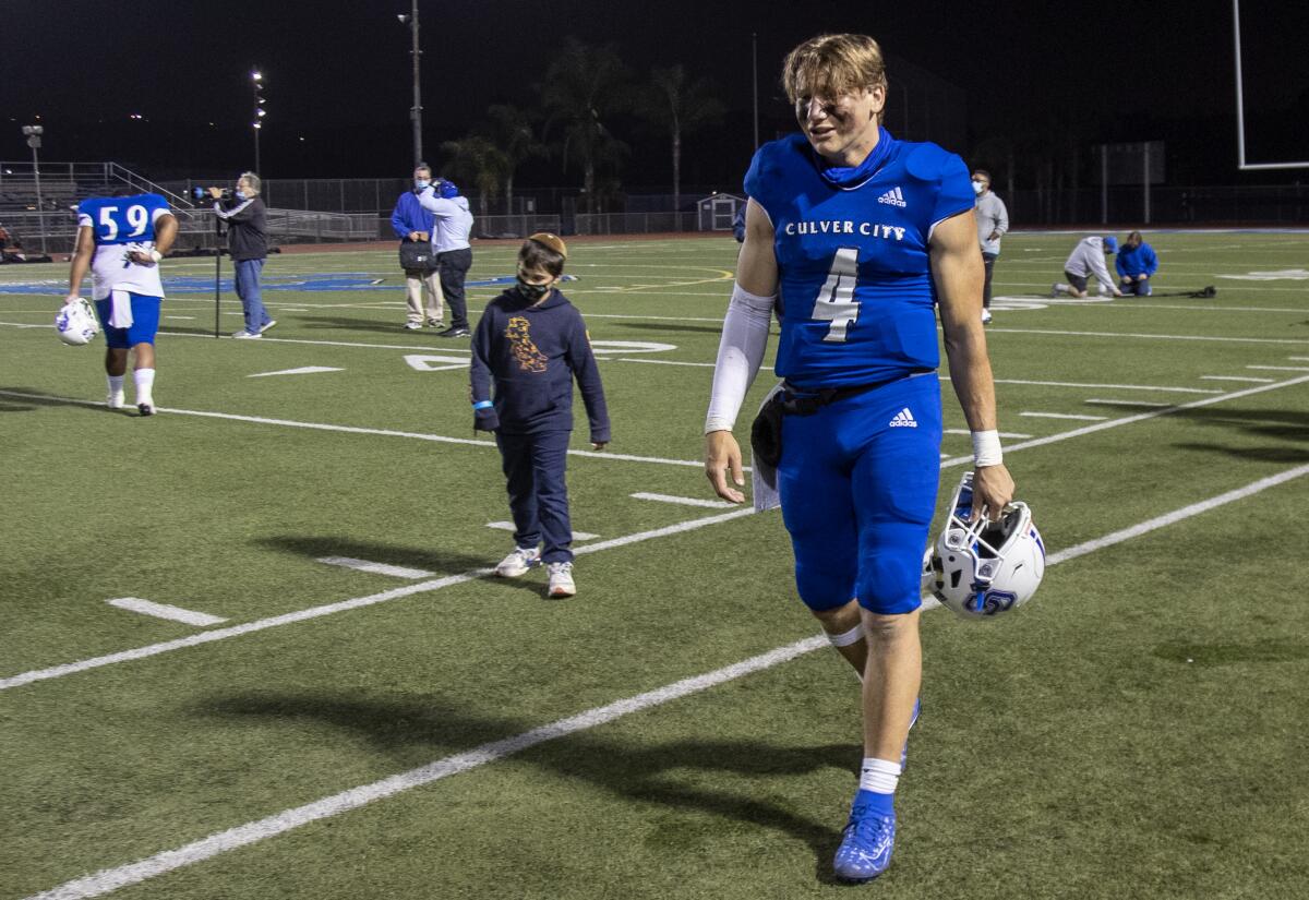 Culver City senior quarterback Zevi Eckhaus walks off the field in 2021 after a heartbreaking loss to Apple Valley.