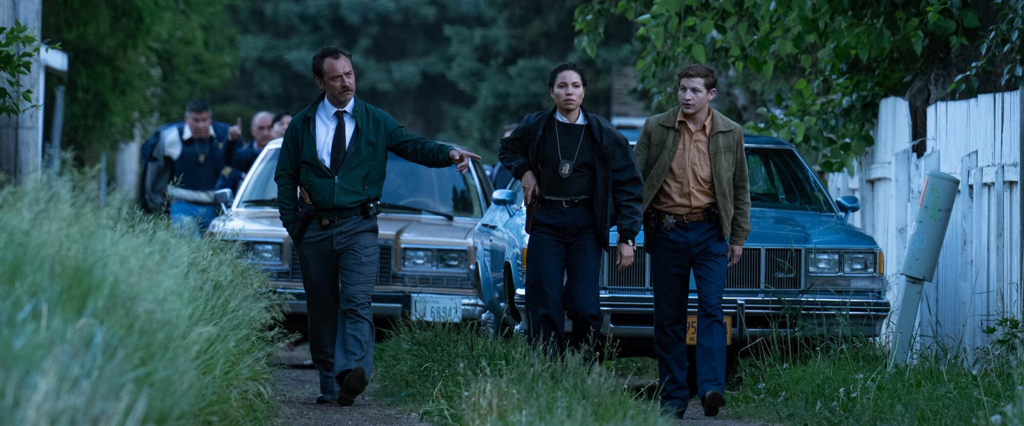 FBI agents walk through the grass in a scene from "The Order."