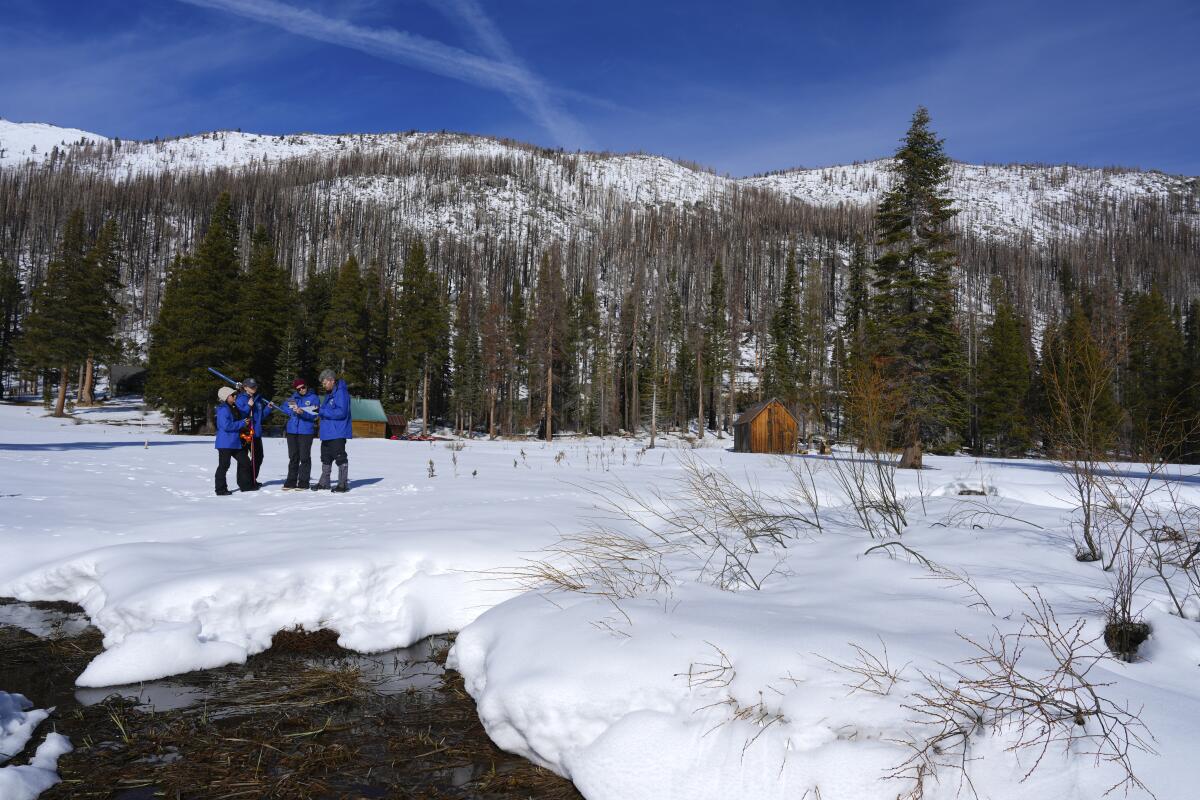 California Department of Water Resources employees conduct the first snow survey of the season at Phillips Station on Jan. 2.