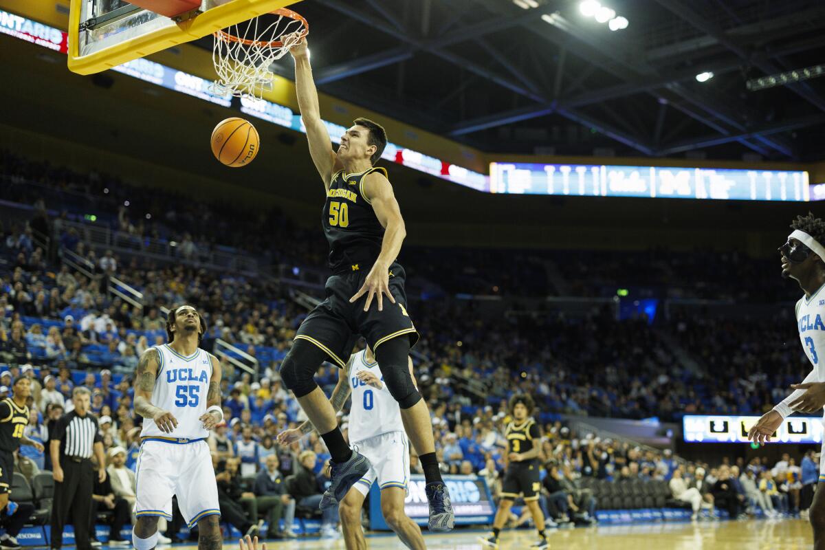 Michigan's Vladislav Goldin dunks in the first half.