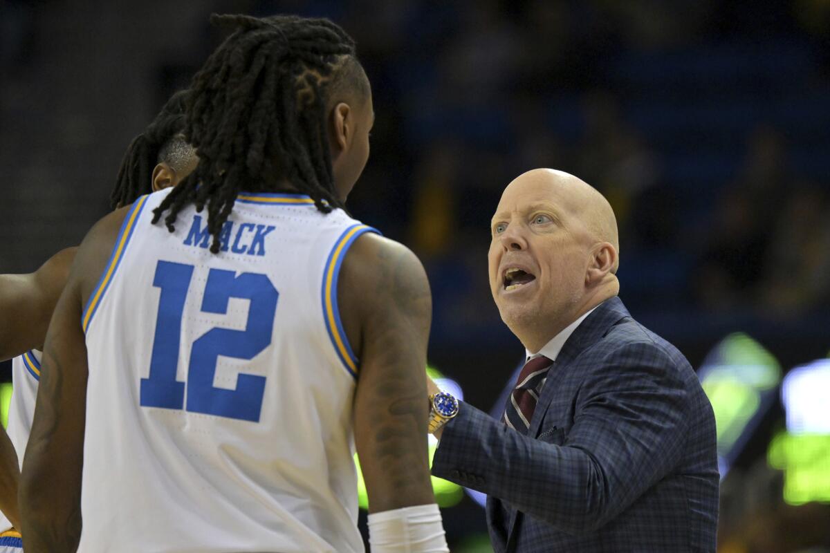 UCLA coach Mick Cronin instructs guard Sebastian Mack during the team's loss to Michigan at Pauley Pavilion Tuesday.