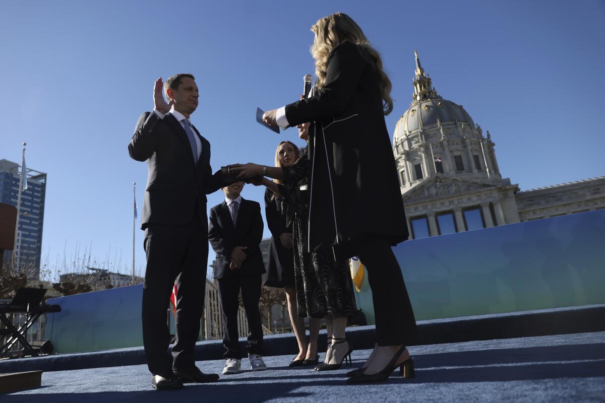 Daniel Lurie, in suit and tie, is sworn in as mayor of San Francisco.