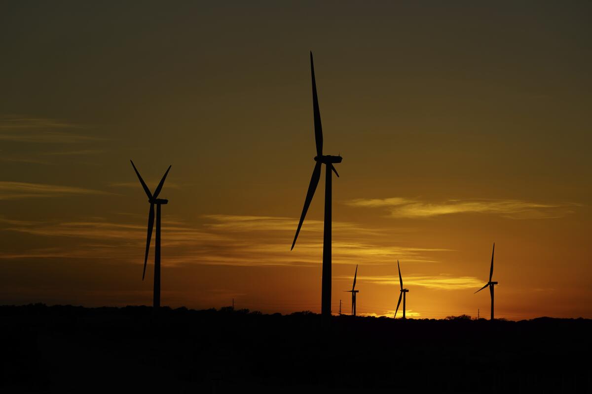 Wind turbines are seen at sunset on a wind farm near Del Rio, Texas, in 2023.