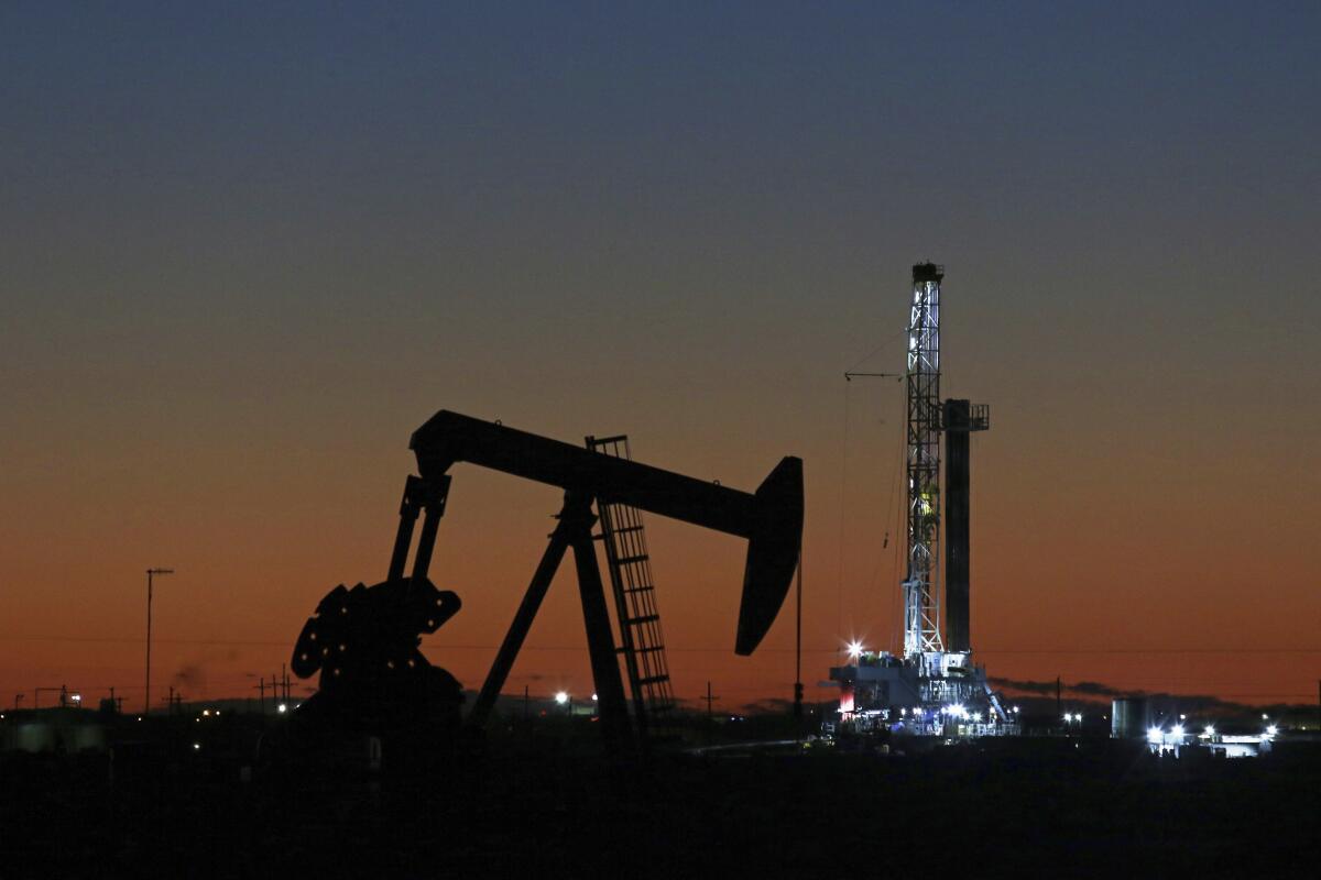 An oil rig and pumpjack in Midland, Texas, in 2018.