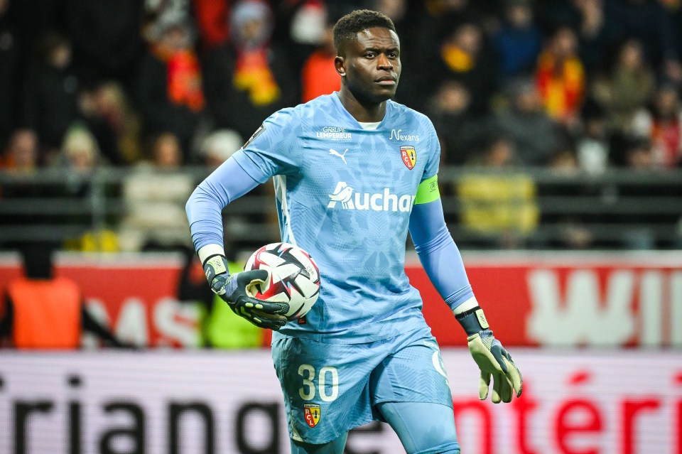 Brice Samba, RC Lens goalkeeper, holding a soccer ball.