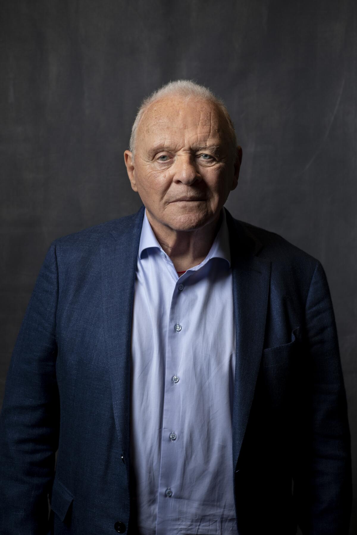 Anthony Hopkins posing in a blue shirt and jacket