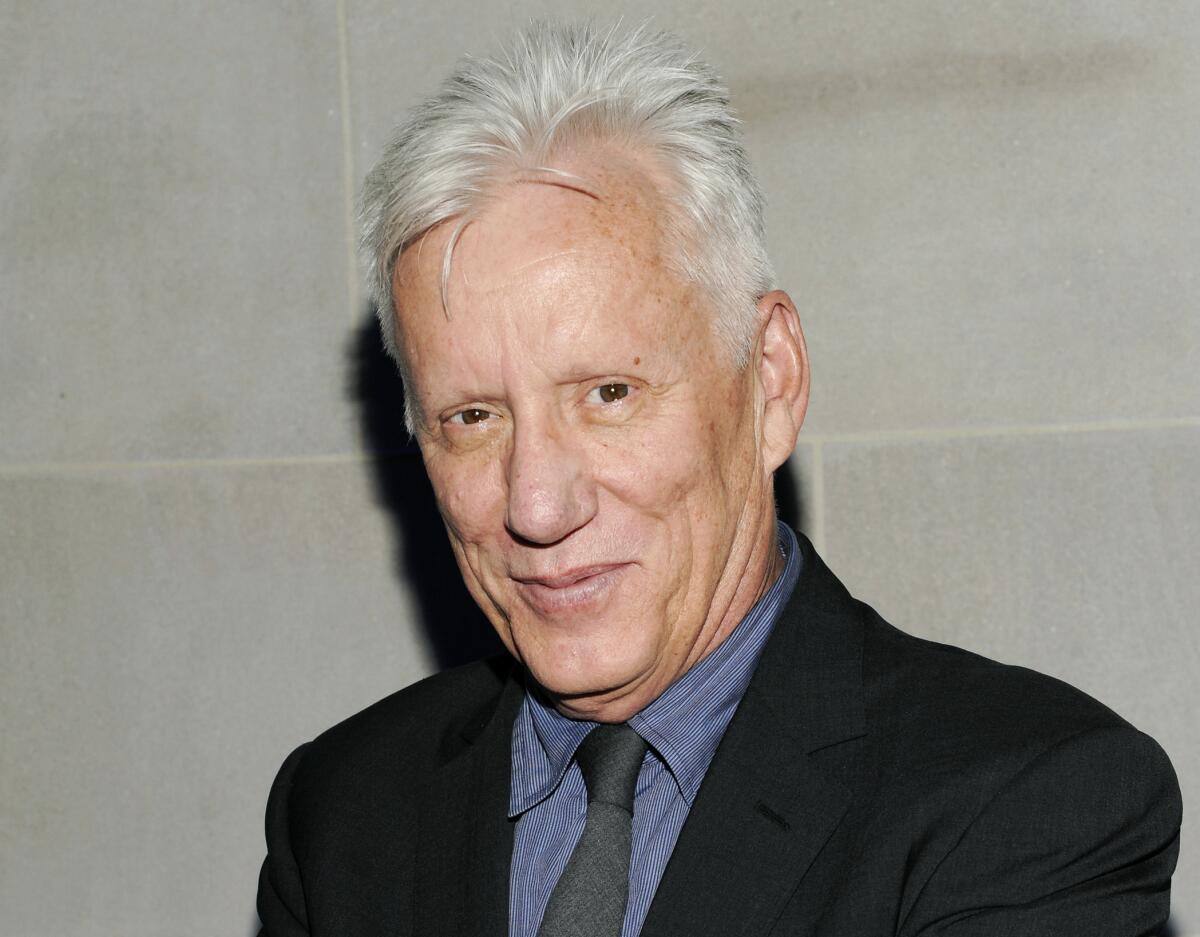 Actor James Woods smiling in a suit