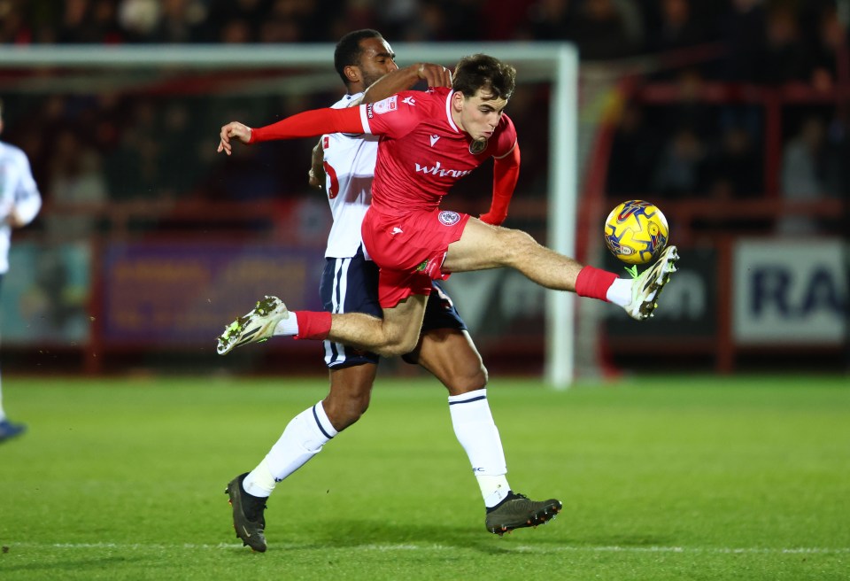 Soccer player kicking the ball during a game.