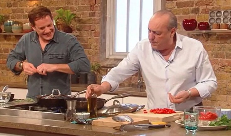 Two chefs cooking in a kitchen.