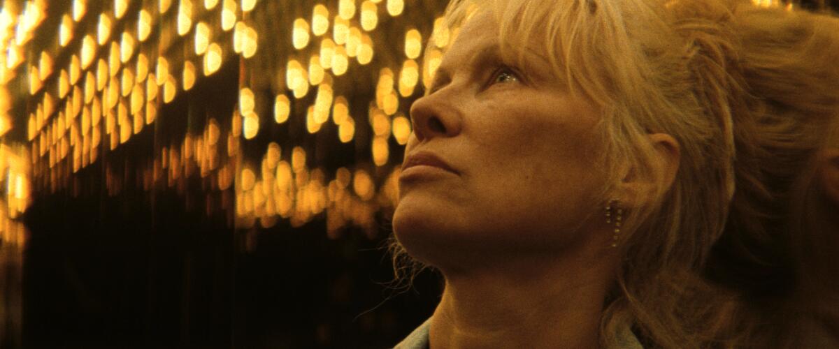 A woman looks at the dizzying lights of Las Vegas.