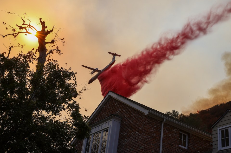 An air tanker drops fire retardant at the Palisades Fire