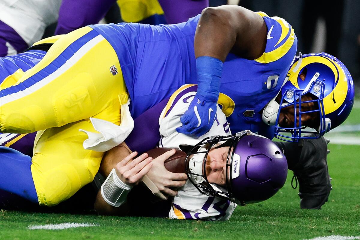 Rams defensive tackle Kobie Turner sacks the Vikings' Sam Darnold in the first quarter of their wild-card playoff game.