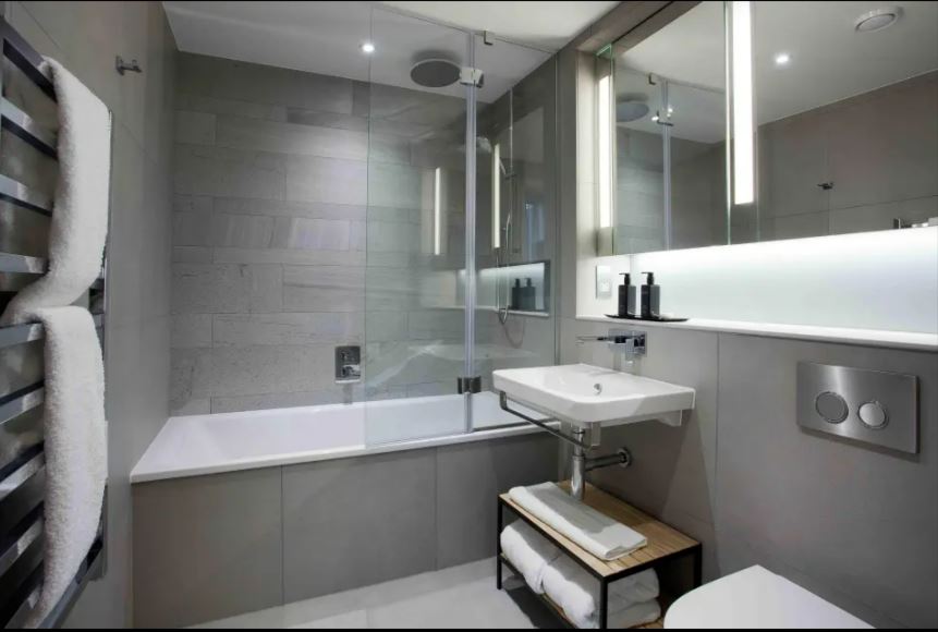 Modern bathroom with bathtub, sink, and shower.