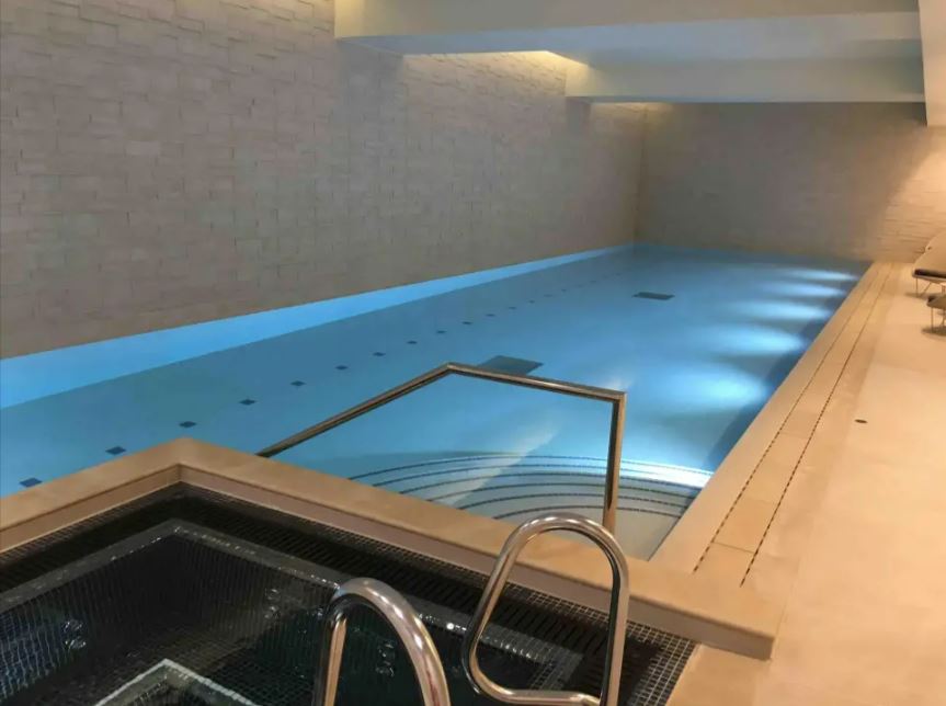 Indoor swimming pool with a hot tub.