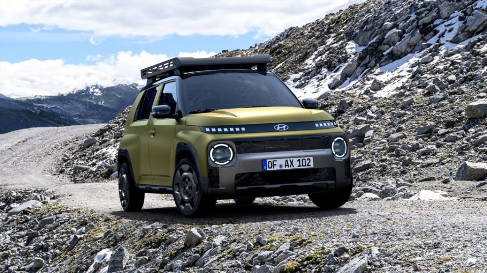 Hyundai INSTER Cross electric city car on a mountain road.