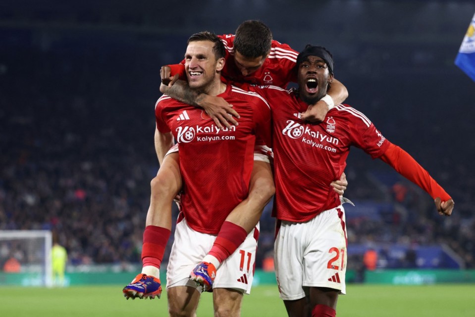 Nottingham Forest's New Zealand striker #11 Chris Wood (L) celebrates with Nottingham Forest's Argentinian midfielder #16 Nicolas Dominguez (C) and Nottingham Forest's Swedish midfielder #21 Anthony Elanga (R) after scoring their second goal during the English Premier League football match between Leicester City and Nottingham Forest at King Power Stadium in Leicester, central England on October 25, 2024. (Photo by Darren Staples / AFP) / RESTRICTED TO EDITORIAL USE. No use with unauthorized audio, video, data, fixture lists, club/league logos or 'live' services. Online in-match use limited to 120 images. An additional 40 images may be used in extra time. No video emulation. Social media in-match use limited to 120 images. An additional 40 images may be used in extra time. No use in betting publications, games or single club/league/player publications. / (Photo by DARREN STAPLES/AFP via Getty Images)