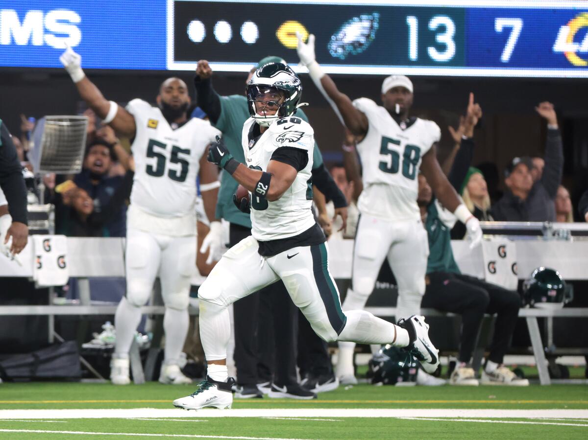 Eagles running back Saquon Barkley runs 70 yards for a touchdown on the first play of the second half against the Rams.