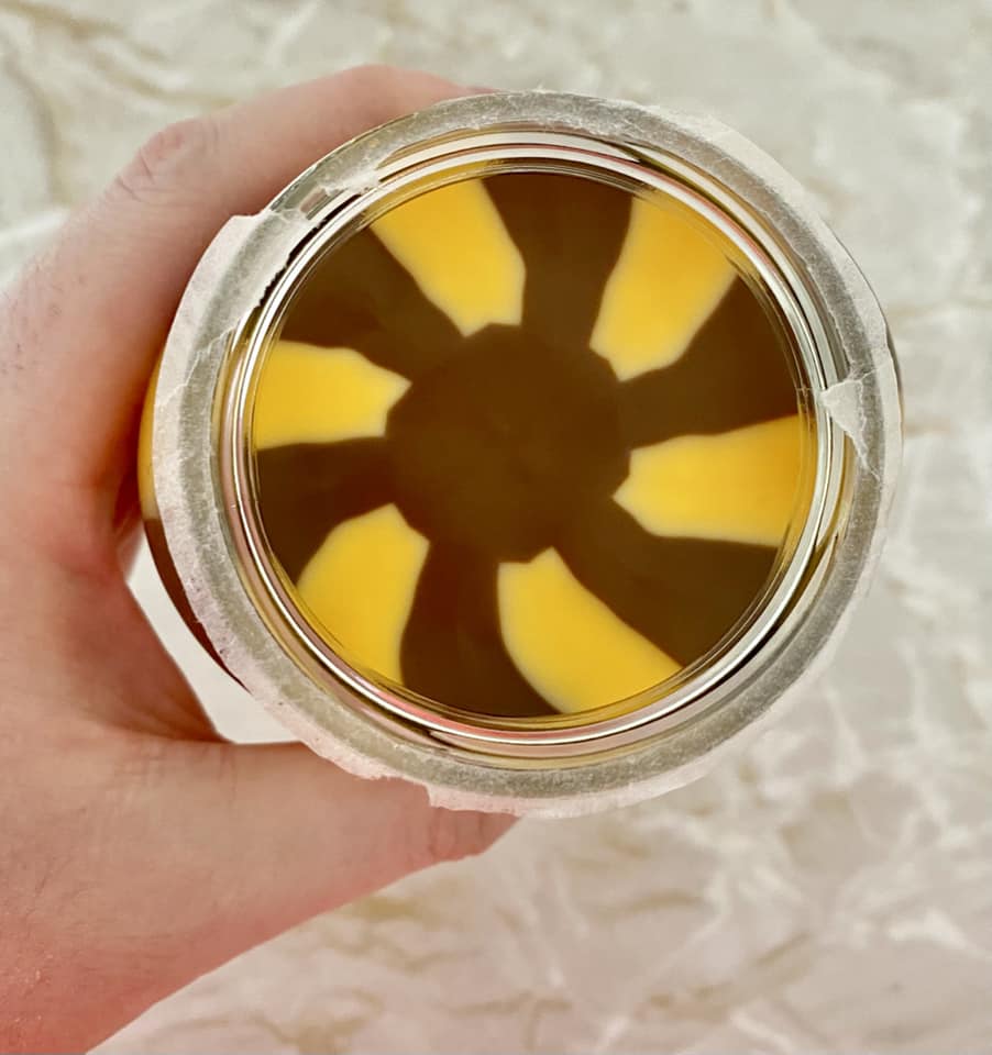 Jar of brown and yellow swirl chocolate spread.