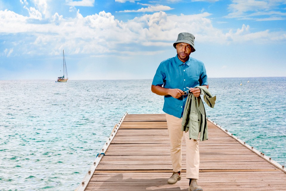 DI Mervin Wilson from Death in Paradise walking on a dock.