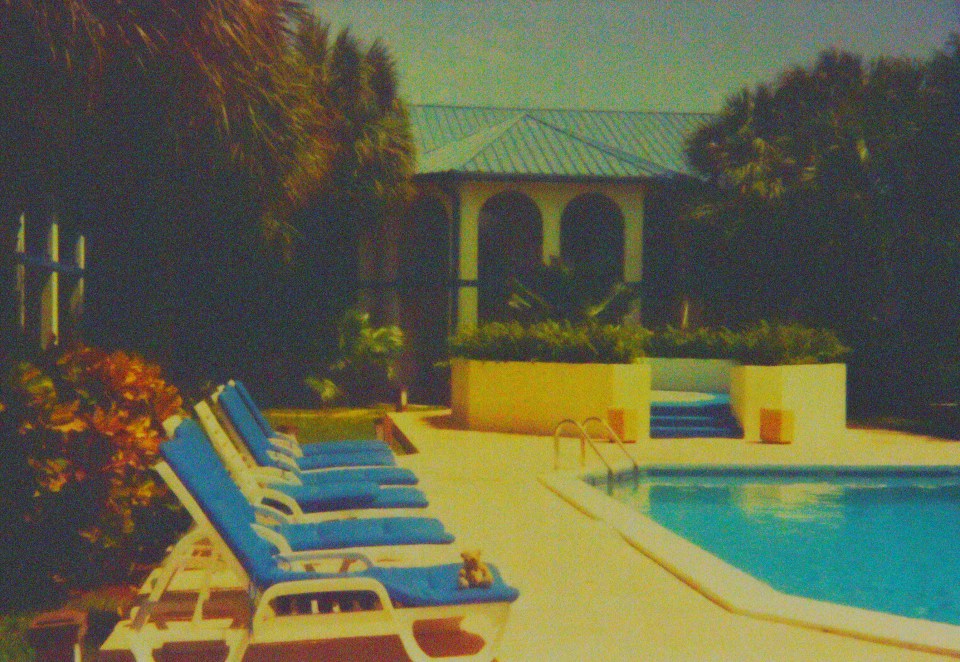 Caribbean Suits hotel pool and lounge chairs.