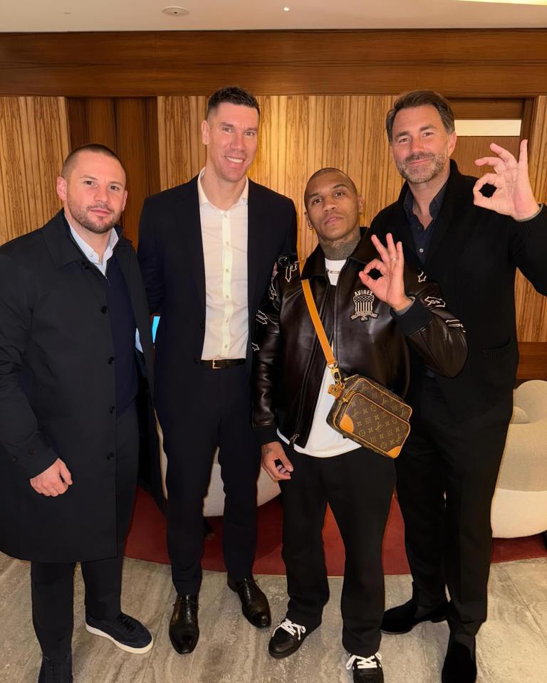 Conor Benn, Eddie Hearn, and two other men posing for a photo.