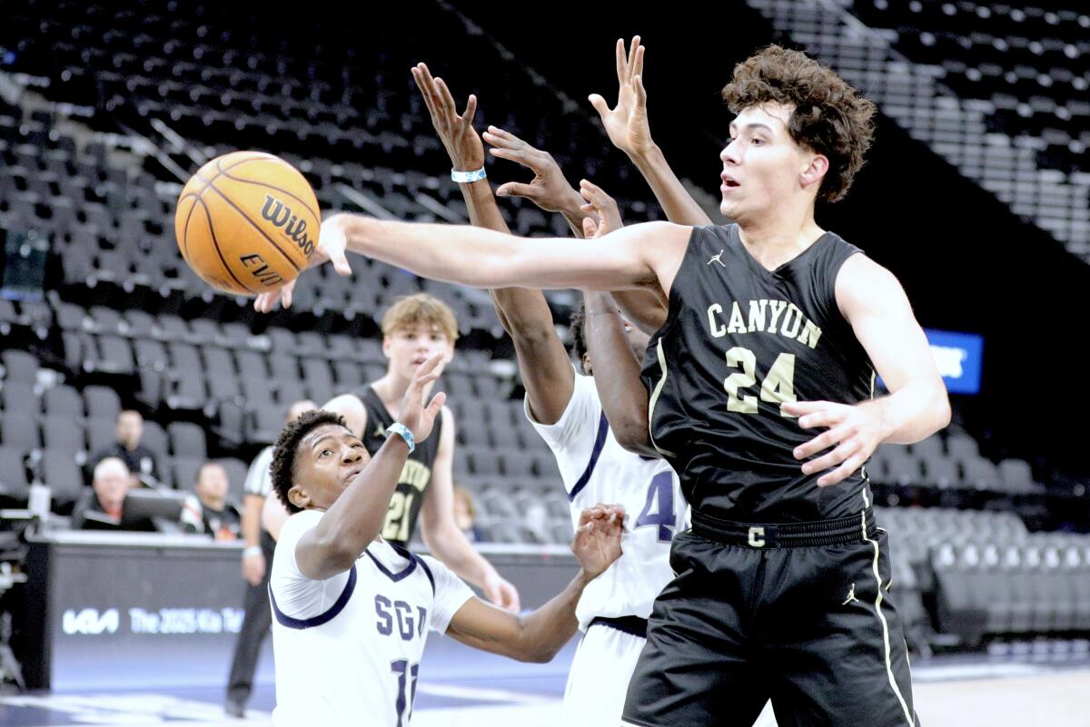 Canyon High's Brandon Benjamin reaches out his right arm to try to grab a rebound.