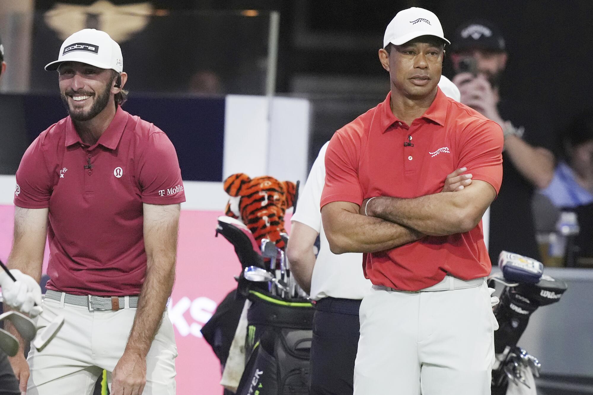 Max Homa, left, and Tiger Woods of the Jupiter Links Golf Club react as they fall behind the Los Angeles Golf Club.