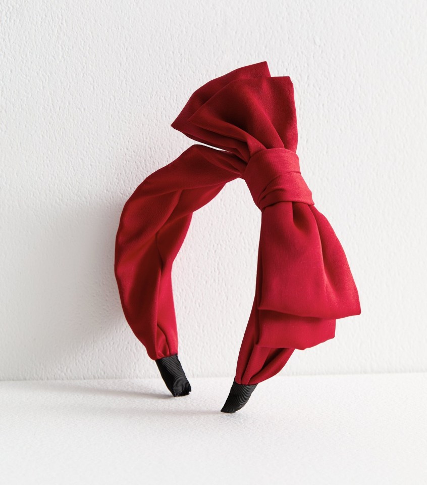 Red fabric headband with a large bow.