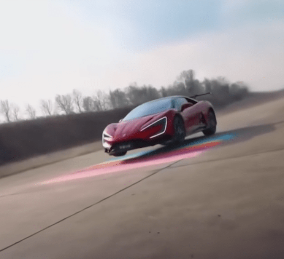 Red Yangwang U9 sports car driving on a track.