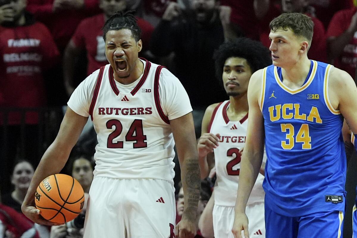 Rutgers center Lathan Sommerville, left, celebrates next to UCLA forward Tyler Bilodeau.