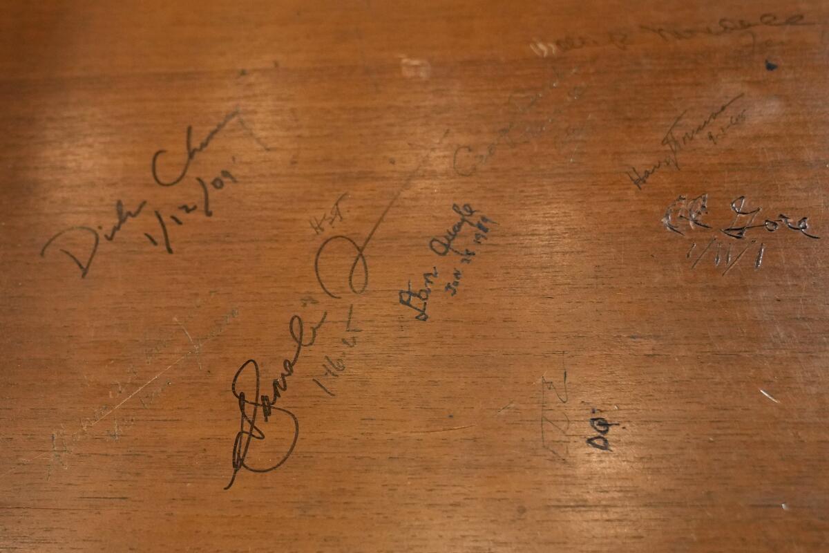 Kamala Harris' and other vice presidents' signatures on a desk drawer in Harris' office in the Executive Office Building.