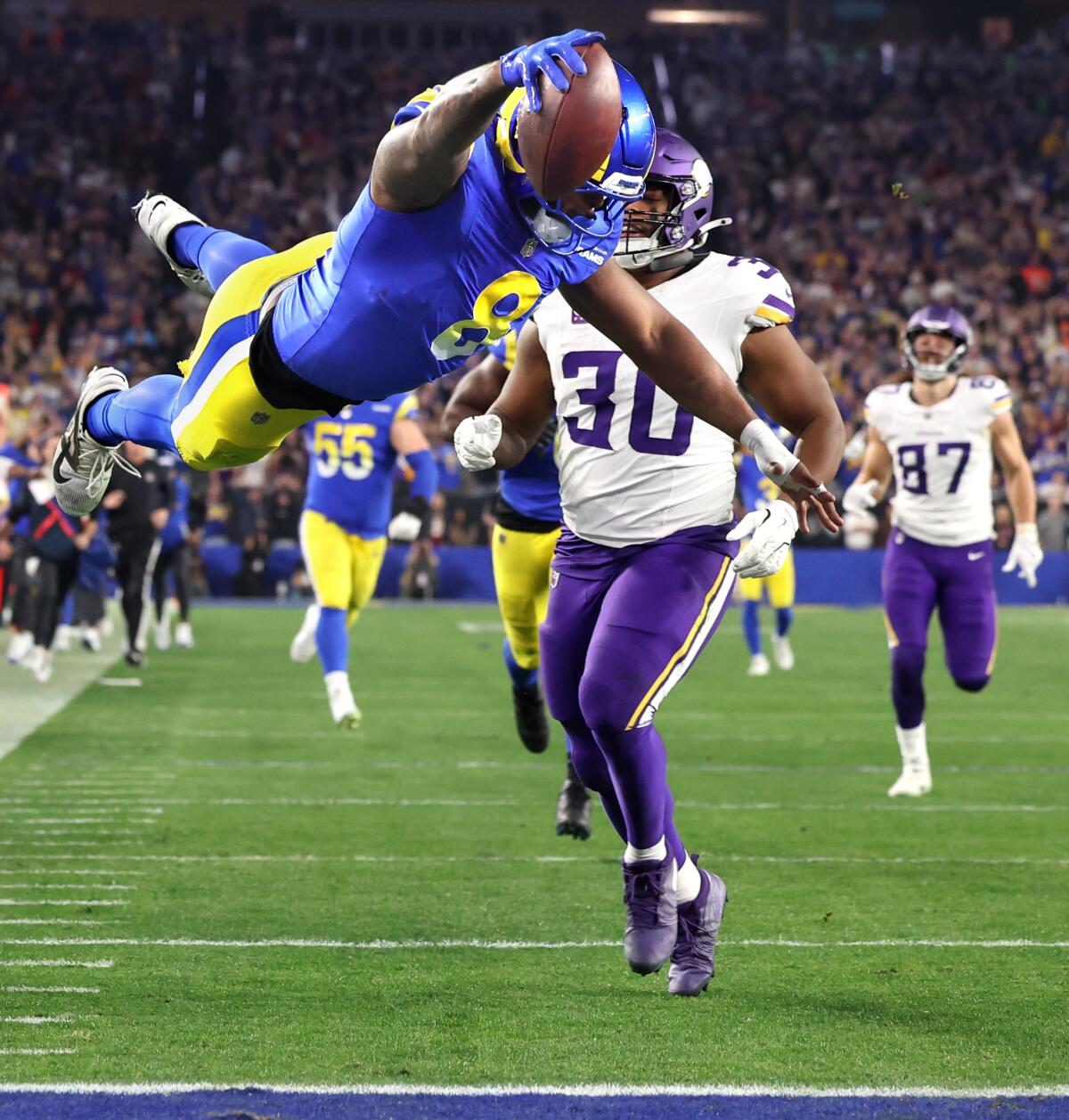 The Rams' Jared Verse dives into the end zone for a score after returning a fumble 57 yards against the Vikings. 