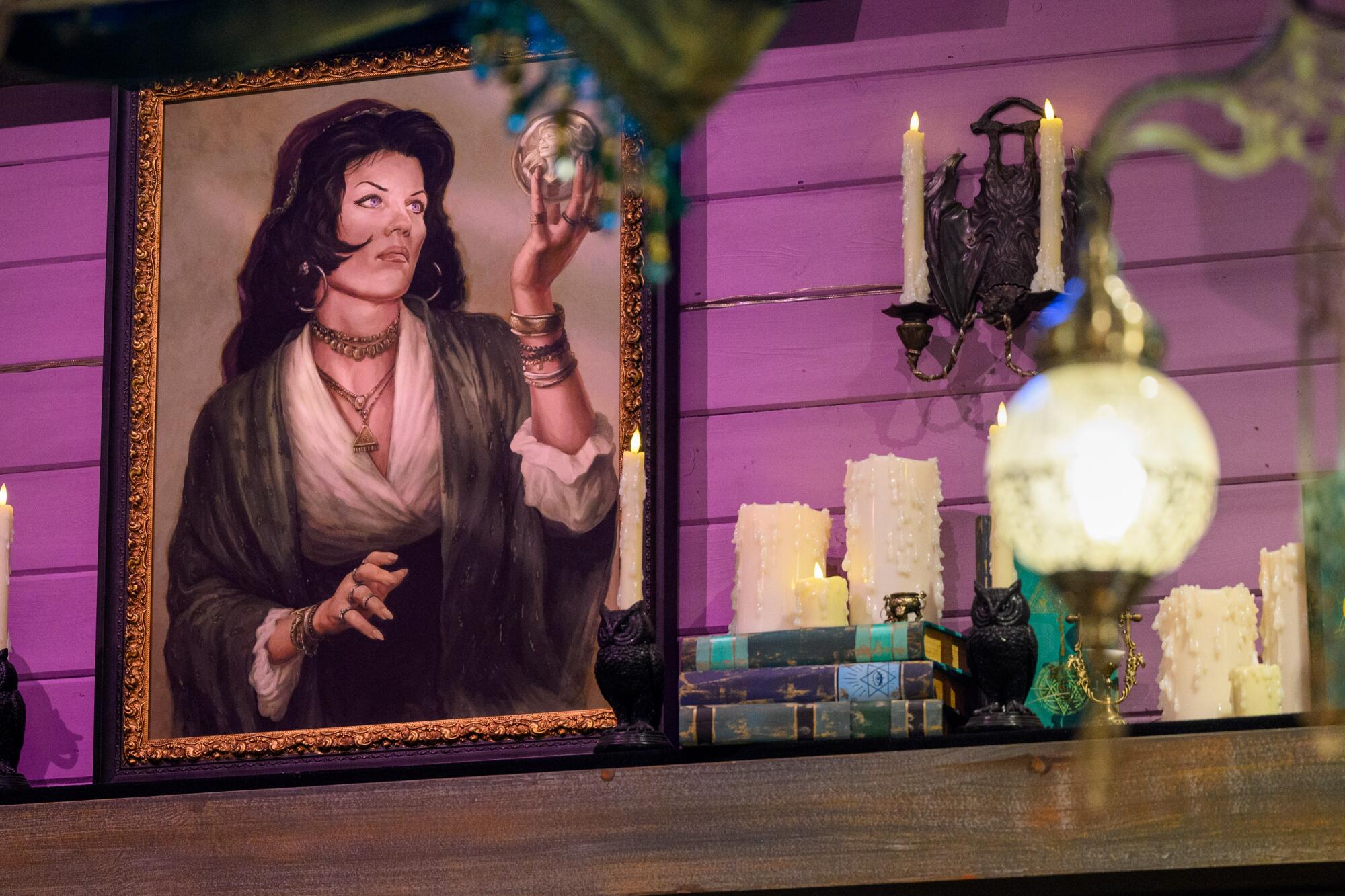 A portrait of a woman holding a crystal ball amid a shelf with candles. 