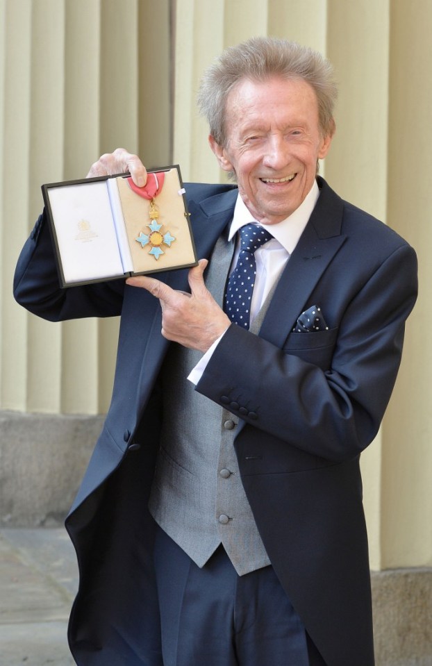 Former Scotland and Manchester United football player Denis Law holds his Commander of the Order of the British Empire (CBE) medal after an investiture ceremony in Buckingham Palace, London on March 11, 2016. / AFP PHOTO / POOL / John StillwellJOHN STILLWELL/AFP/Getty Images