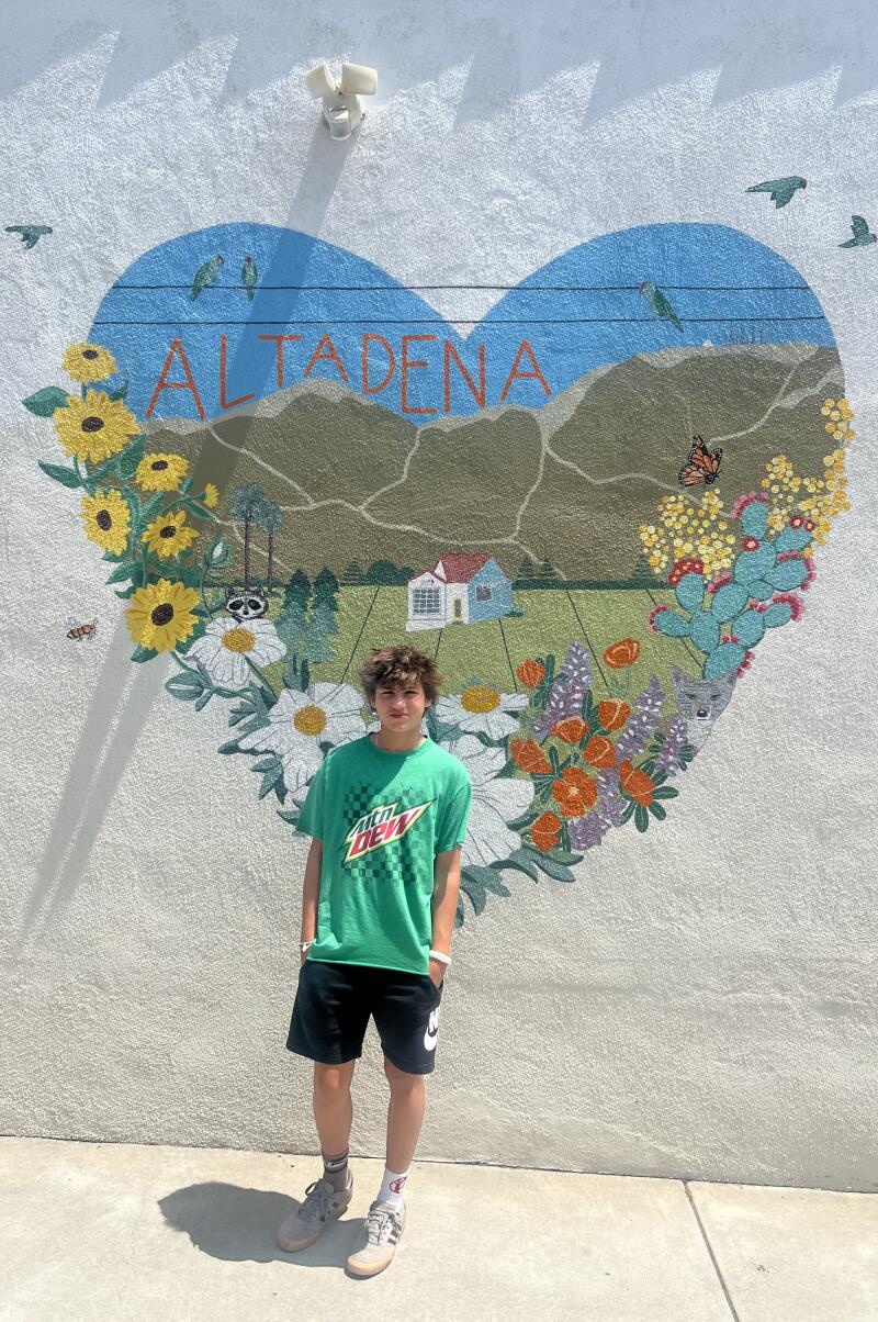 Bird Sowersby stands in front of a heart mural in Altadena