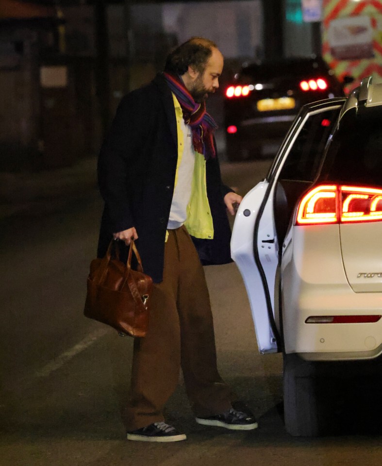 Man getting into a car after a leaving party.